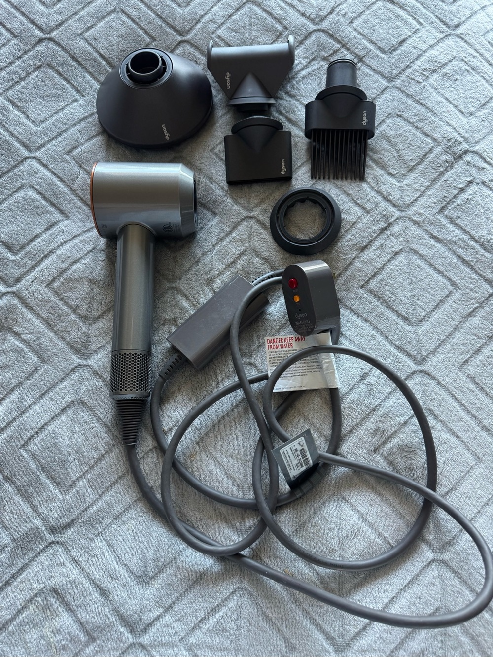 Dyson Hair Dryer with Multiple Black and Gray Styling Attachments